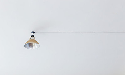 a lamp on a white ceiling with cables