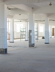 Unfinished interior of business center under construction in grey colours