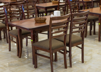 Fototapeta na wymiar a lot of wooden, brown chairs in a cafe