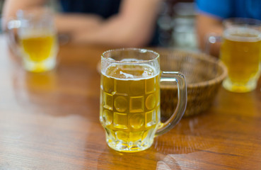 mug of beer on wooden background