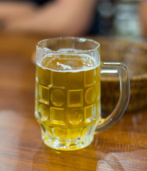 mug of beer on wooden background