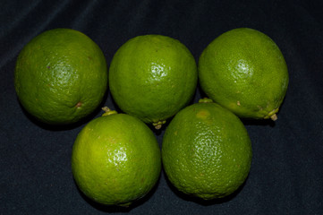 green lime tahiti, or taiti lemon or Citrus latifolia, isolated on black background