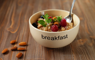 Oatmeal with fresh berries and nuts close up