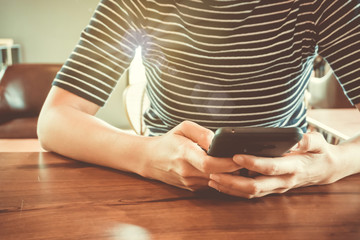 Woman hand using smartphone or tablet to do business, financial or trading stock forex market in park outdoor nature road background.