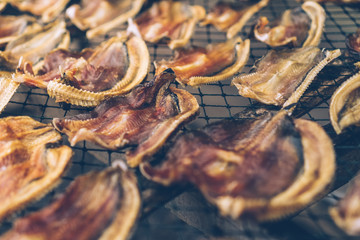 Food preservation of fish make it dried by sun baht on grille.