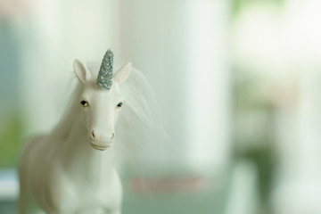Unicorn toy for decorate home and cafe shop with blur bokeh background