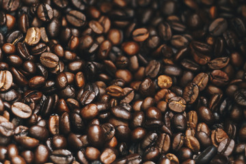 Roasted coffee bean background as dark tone background.