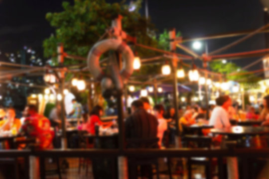abstract blur image of night festival in a restaurant and The atmosphere is happy and relaxing with bokeh for background, Bangkok Thailand.