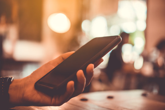 Woman hand using smartphone or tablet to do business, financial social network with mountain view nature background - Powered by Adobe