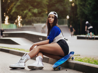 beautiful sexy girl with long legs wis a skateboard - obrazy, fototapety, plakaty