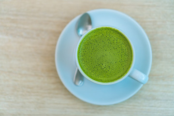 Top view of Matcha green tea latte on wood table in cafe 