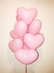 There are many gently pink helium balloons. A gift for your girlfriend and a declaration of love. Valentine's Day