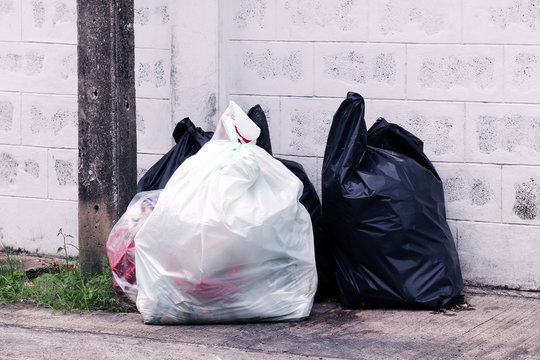 garbage is pile lots dump, many garbage plastic bags black waste at walkway community village, pollution from trash plastic waste garbage, bags bin of plastic waste, pile garbage waste, lots junk dump
