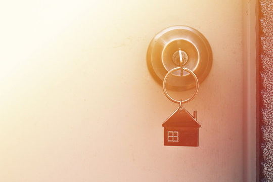 Property Concept, Home key with metal house keychain in keyhole