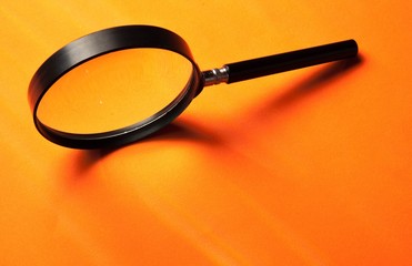 Black Loupe on Orange Background
