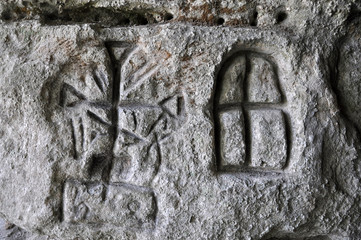 Ancient Germanic runes on the wall of the cave