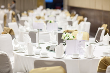 wedding table sets in wedding hall. wedding decorate preparation. table set and another catered event dinner, luxury wedding table setting for fine dining at indoors.