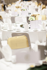 wedding table sets in wedding hall. wedding decorate preparation. table set and another catered event dinner, luxury wedding table setting for fine dining at indoors.