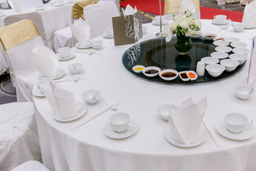 wedding table sets in wedding hall. wedding decorate preparation. table set and another catered event dinner, luxury wedding table setting for fine dining at indoors.