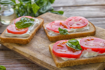 Crostini with toasted gray bread, cottage cheese and slased tomatoes .