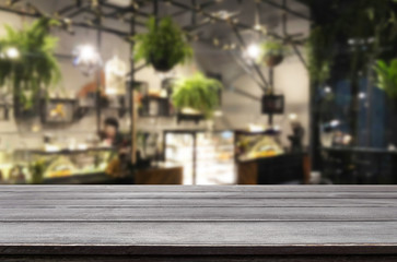 Fototapeta na wymiar Selected focus empty brown wooden table and Coffee shop or restaurent blur background with bokeh image. for your photomontage or product display