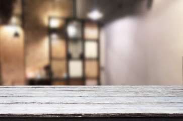 Selected focus empty brown wooden table and Coffee shop or restaurent blur background with bokeh image. for your photomontage or product display