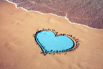 inscription heart on beach sand
