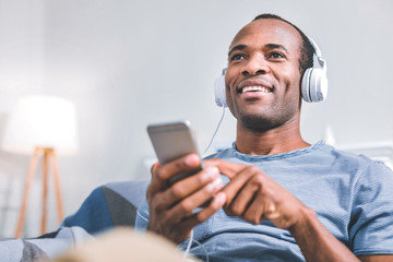 Favourite singer. Cheerful nice man enjoying the music while having a day off