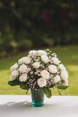 Wedding flower composition. Bouquet with big white roses and chamomiles