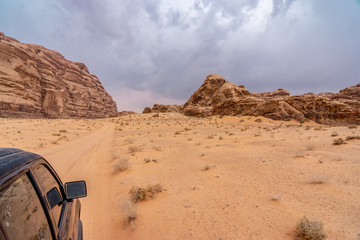 Desert road in Wadi Rum. View from offroad car