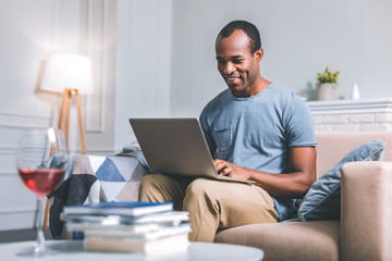 Remote job. Smiling nice man working remotely