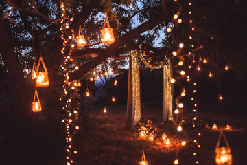 Night wedding ceremony with a lot of lights, candles, lanterns. Beautiful romantic shining...