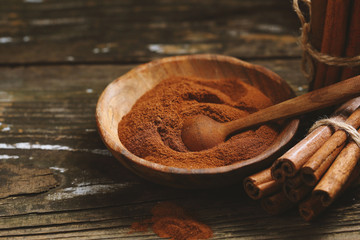Cinnamon powder and sticks on boards