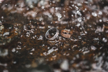 Wedding rings on water surface texture