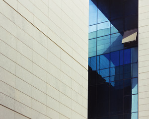 External facade of a modern office block with one single windows raised and open