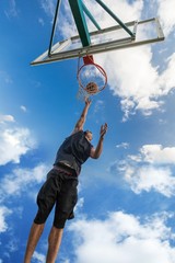 Low Angle View of Basketball Player Dunking Ball © BillionPhotos.com