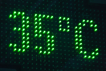 Outdoor thermomether display with green lights. Hot summer. 35