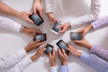 Obraz na płótnie Canvas Group Of Businesspeople Using Smartphone