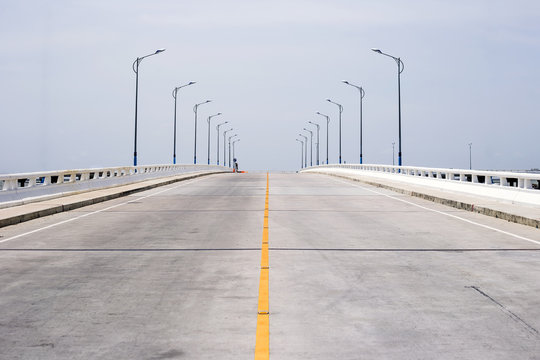 Slope of concrete road and clear sky background.