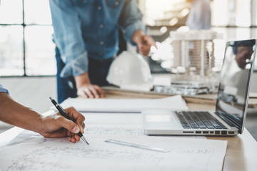 Hands of architect or engineer working on blueprint meeting for project working with partner on model building and engineering tools in working site, Construction concept