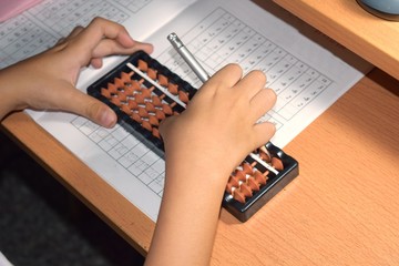 a boy doing abacus homework, education concept