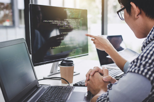 Programmers cooperating at Developing programming and website working in a software develop company office, writing codes and typing data code