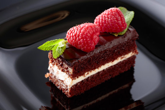 Chocolate cake with raspberry and mint .