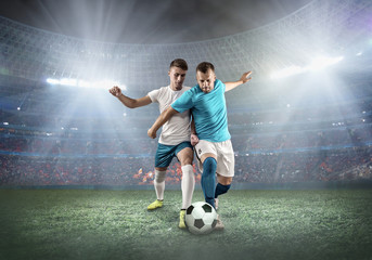 Soccer player on a football field in dynamic action at summer day