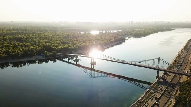 Kiev (Kiyv) Ukraine capital. River Dnepr (Dnipro) Parkivyi Bridge to Truhaviv island Aerial drone video footage from above. Sunrise time
