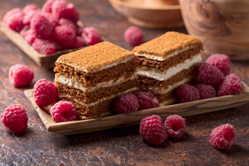 Layered honey cake with cream and raspberries.