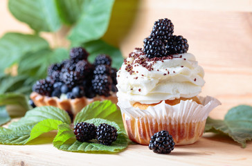 Tasty blackberry cakes with berries and cream.