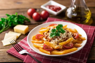 Pasta bolognese with tomato sauce and minced meat, grated parmesan cheese and fresh basil - homemade healthy italian pasta on rustic wooden background.