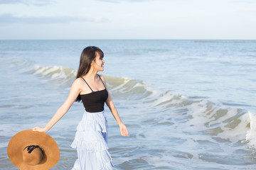 Fototapeta na wymiar Beautiful girl smiling happily on a sunny day, Hua Hin beach, Thailand