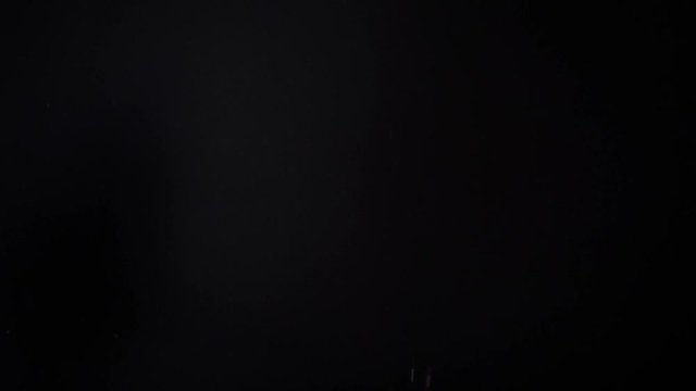 potato chips in free fall on a black background. Slow motion. The view from the side. Pringles